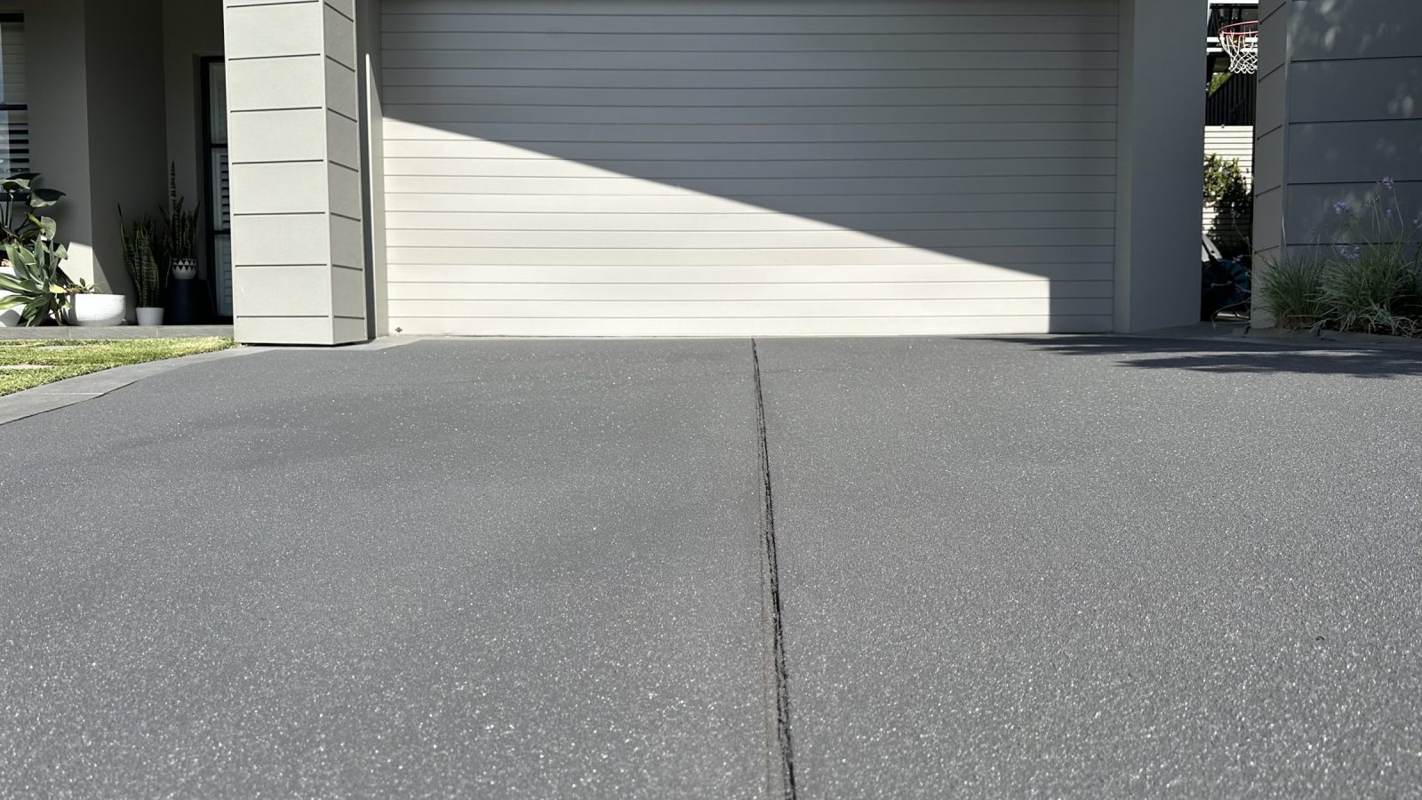 Pebblecrete driveway after resurfacing, with the pebble texture flattened