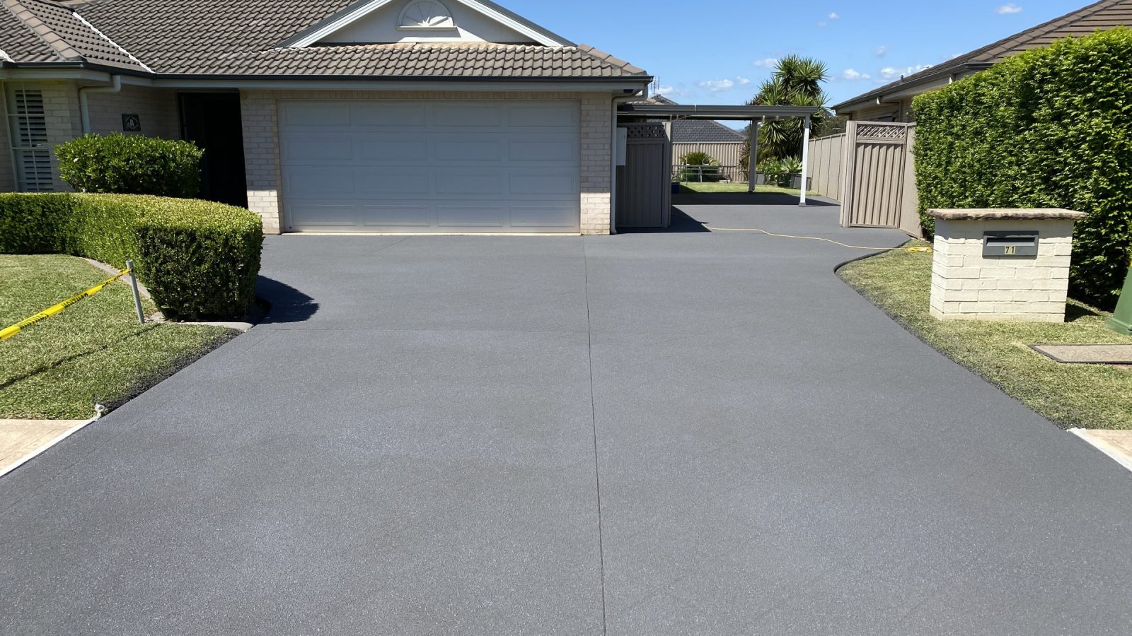 Driveway after stencil pattern removal, resurfaced to a flat uniform finish