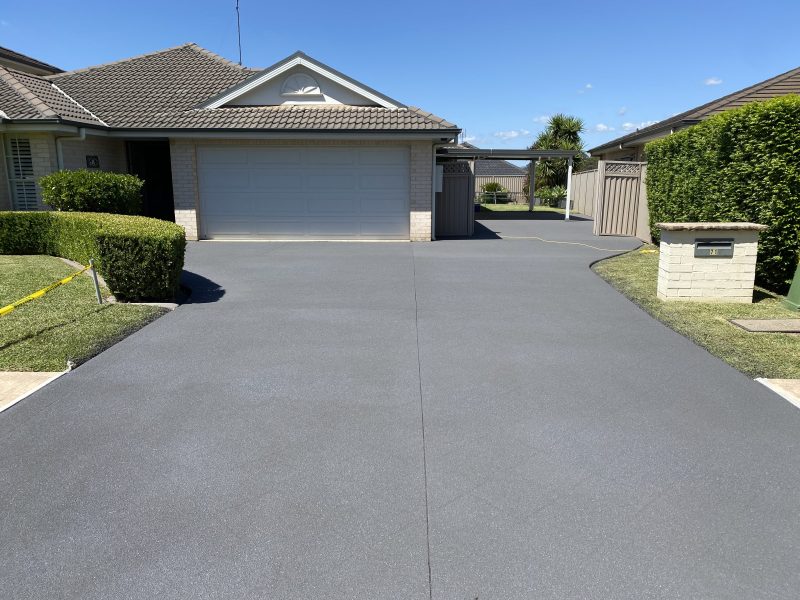 Driveway after stencil pattern removal, resurfaced to a flat uniform finish