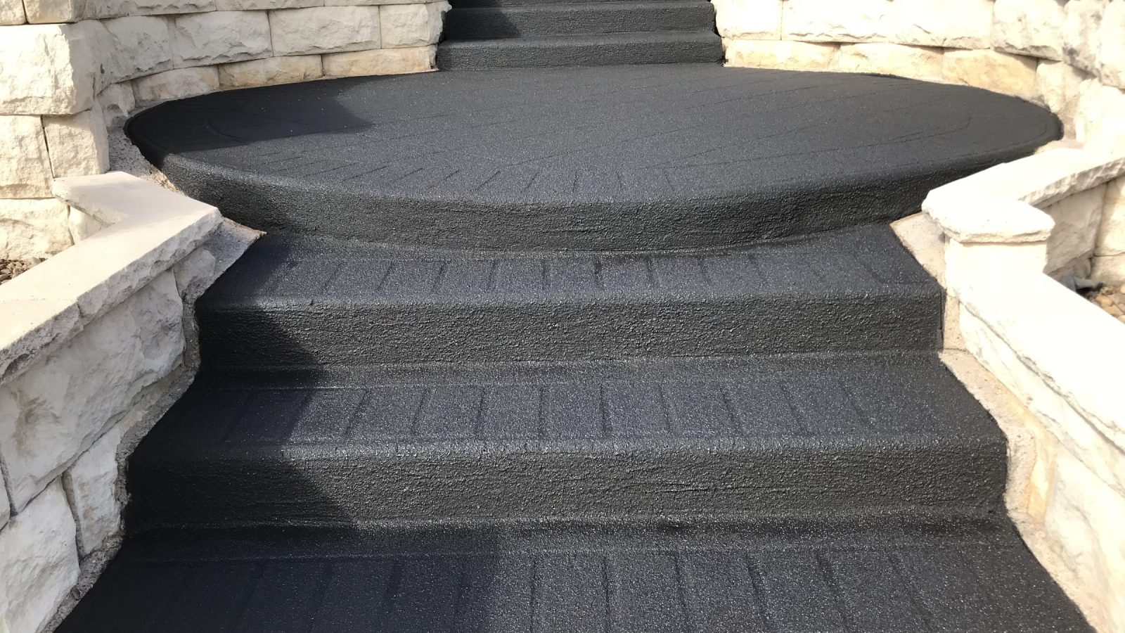 Stencil pattern driveway resurfaced with the pattern still faintly visible
