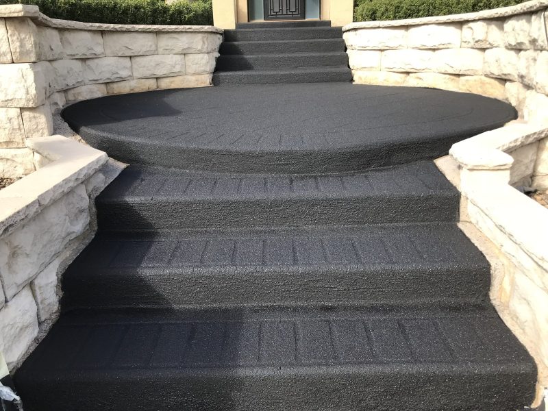 Stencil pattern driveway resurfaced with the pattern still faintly visible